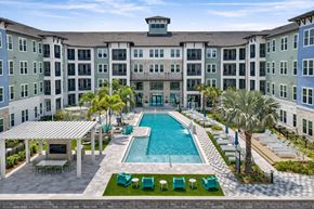 Orlando apartment for rent - A large building with a pool in front.