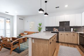 Eagle apartment for rent - an open kitchen and living room with a marble counter top