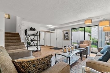 Eden Prairie townhouse for rent - A living room with a brown couch and a glass table.