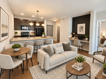 Fargo apartment for rent - A modern living room with a grey couch and a wooden coffee table.