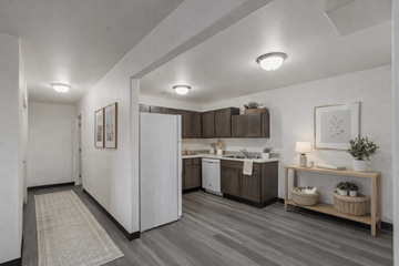 Moscow apartment for rent - A modern kitchen with a white refrigerator and wooden cabinets.