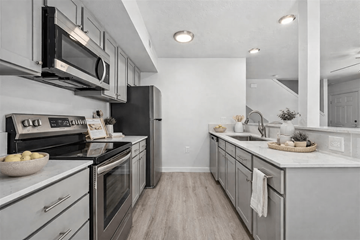 Boise townhouse for rent - A modern kitchen with a black refrigerator and stove top oven.