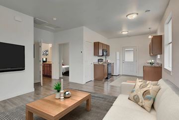 Helena apartment for rent - A modern living room with a wooden coffee table and a large flat screen TV.