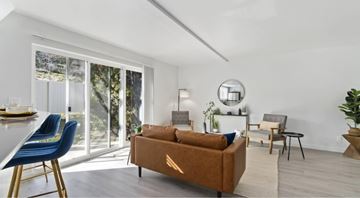 Boise apartment for rent - A living room with a brown couch and blue chairs.