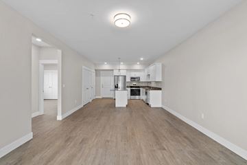 Wenatchee apartment for rent - A spacious kitchen with white cabinets and a central island.