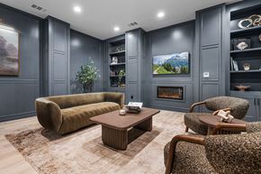 Roseville townhouse for rent - A living room with a fireplace and a painting on the wall.