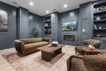 Roseville townhouse for rent - A living room with a fireplace and a painting on the wall.