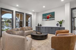 Roseville townhouse for rent - A living room with a brown chair and a grey couch.
