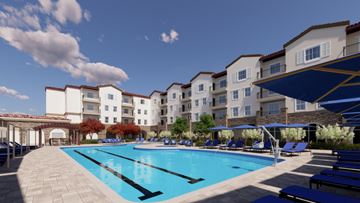 Morgan Hill townhouse for rent - A large swimming pool is surrounded by sun loungers and apartment buildings.