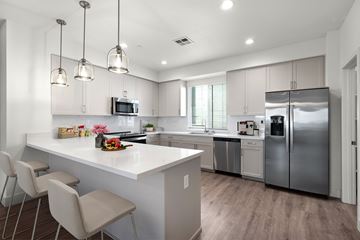 Morgan Hill townhouse for rent - A modern kitchen with a white island and stainless steel appliances.