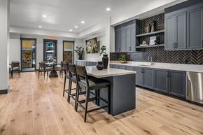 Roseville townhouse for rent - A kitchen with a large island and bar stools.