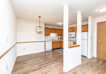 Milwaukee apartment for rent - A kitchen with wooden cabinets and a white fridge.