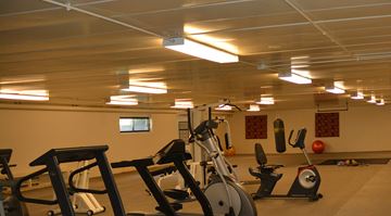 Madison apartment for rent - A gym with exercise equipment and a mirror on the wall.