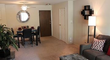 Madison apartment for rent - A living room with a grey couch and a black table.