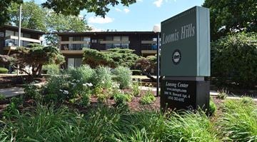 Greenfield apartment for rent - A sign for Loomis Hills Leasing Center stands in front of a building.