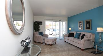 West Allis apartment for rent - A living room with a white couch and a glass coffee table.