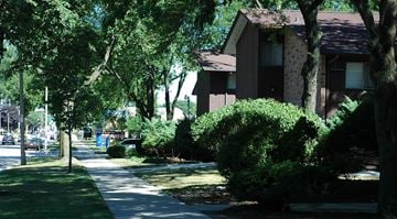 Milwaukee apartment for rent - A tree-lined street with apartment buildings on the right.