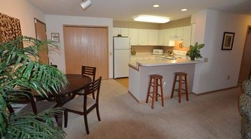 Sun Prairie apartment for rent - A kitchen with a table and chairs in the middle of the room.