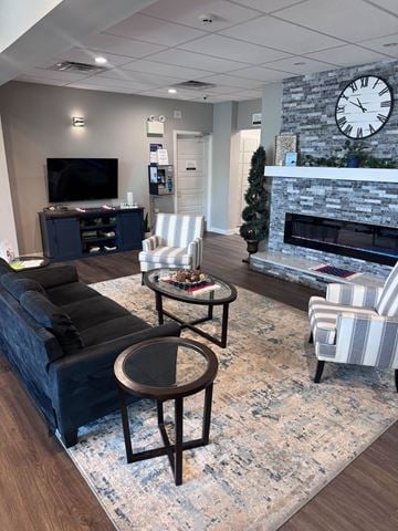 Maple Shade apartment for rent - A living room with a fireplace and a large clock on the wall.