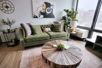 Omaha apartment for rent - A living room with a green couch and a wooden coffee table.
