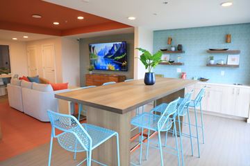 Marathon apartment for rent - A modern dining room with a wooden table and blue chairs.
