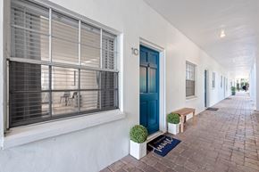 Tampa apartment for rent - a white house with a blue door and window