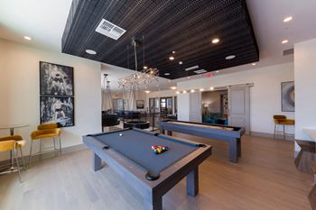 Recreation room with billiard tables and bar seating