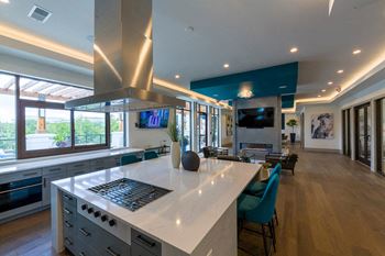 Open concept kitchen with island cooktop and living space