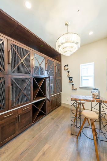 Wine room with mesh cabinet doors and bar seating