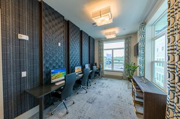 Business center with computer workstations and textured wall panels