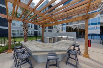 Outdoor kitchen with grilling station and bar seating