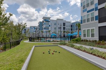 Bocce ball court with residential buildings and pool area