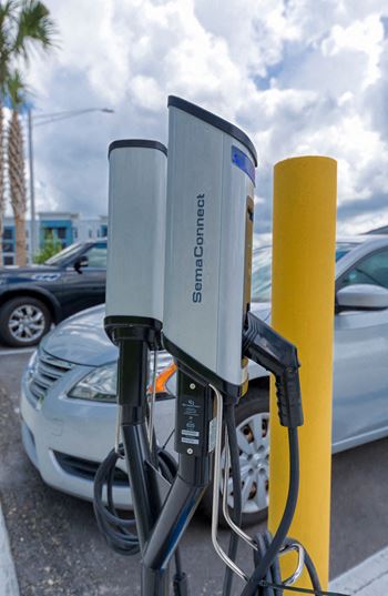 Electric car charging station in parking area
