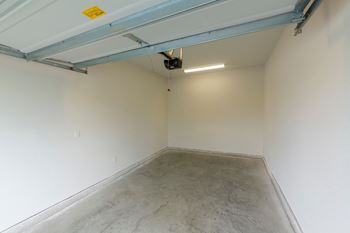 Empty garage space with concrete floor