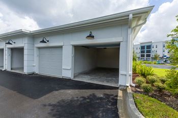 Covered parking garage with open bay doors