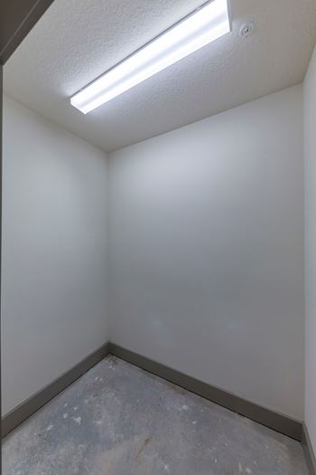 Empty closet with overhead fluorescent lighting