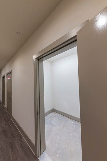 Open closet space with concrete flooring