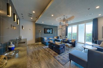 Clubhouse lounge with blue seating and chandelier