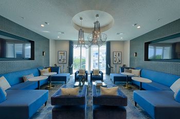 Modern resident lounge with pendant lighting and seating areas