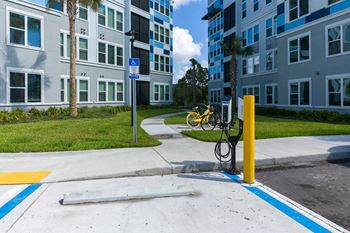 Electric vehicle charging station with yellow safety bollard