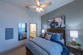 Jacksonville apartment for rent - Bedroom with blue linens and artwork at Ciel Luxury Apartments, Jacksonville, FL