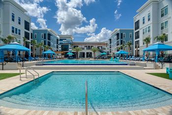 Resort style swimming pool with spa and lounge seating