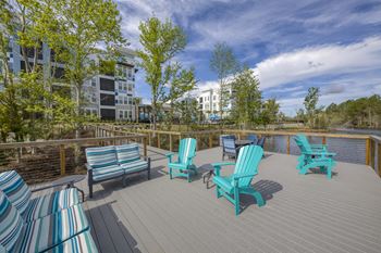 Waterfront deck with turquoise chairs and lake views