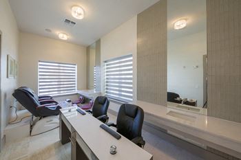 Hair salon styling station with black chairs