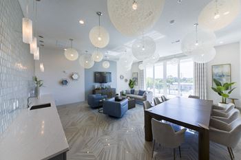 Open concept living and dining area with pendant lighting