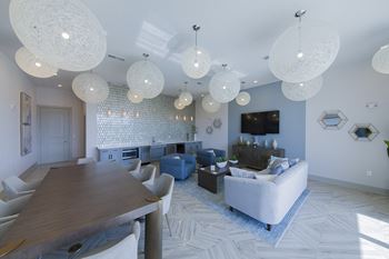 Clubhouse lounge with spherical pendant lights and seating