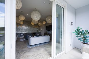 Modern lounge with woven pendant lights and mosaic backsplash