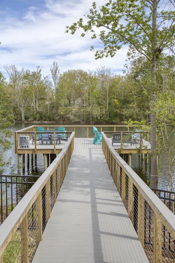 Lakeside boardwalk with outdoor seating and water views