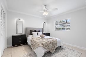 Tampa apartment for rent - a bedroom with a bed and a ceiling fan