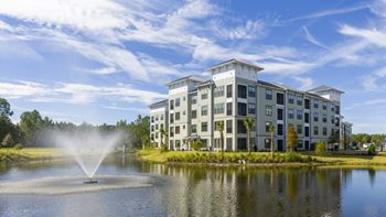 Modern apartment building with lakefront fountain